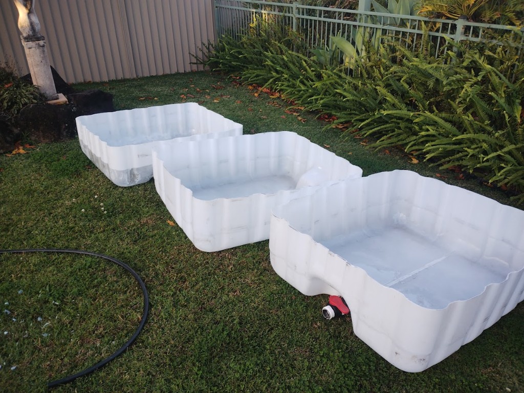Three cut IBC tote bases ready to use as aquaponics grow beds