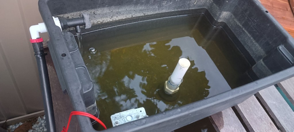 Sump tank plumbing with water inlet, standpipe and submerged pump wiring