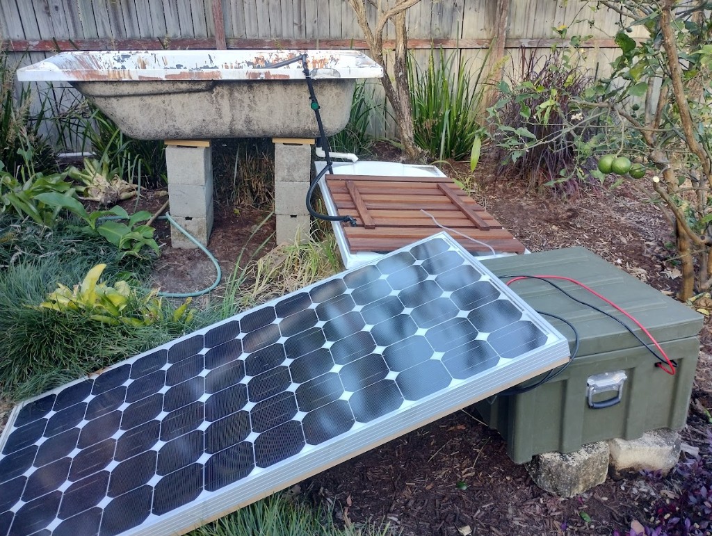 Original two-bathtub aquaponics system on solar power with besser block supports